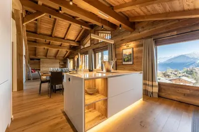 a kitchen with wooden ceilings and a large window at Le Chalet Baan - avec vue sur les montagnes in Combloux