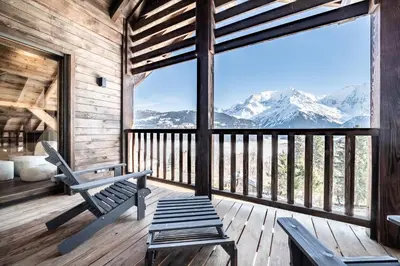 a porch of a cabin with a view of mountains at Chalet 4 Mésanges, Saint-Gervais -Le Bettex - by EMERALD STAY in Saint-Gervais-les-Bains