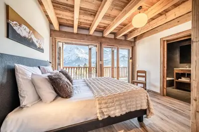 a bedroom with a bed with a mountain view at Chalet 4 Mésanges, Saint-Gervais -Le Bettex - by EMERALD STAY in Saint-Gervais-les-Bains