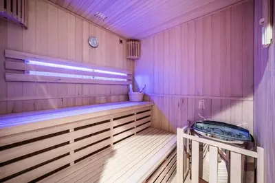 a large wooden sauna with a bench in it at Chalet 4 Mésanges, Saint-Gervais -Le Bettex - by EMERALD STAY in Saint-Gervais-les-Bains