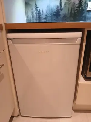 a dishwasher in a kitchen under a window at Magnifique studio Megève in Megève