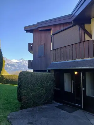 a house with a bush in front of it at Magnifique studio Megève in Megève