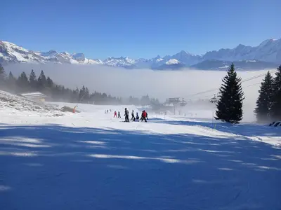 a group of people skiing down a snow covered slope at Magnifique studio Megève in Megève
