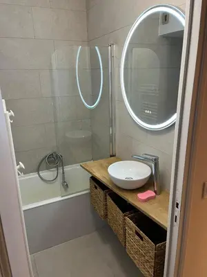 a bathroom with a sink and a shower with a mirror at Magnifique studio Megève in Megève