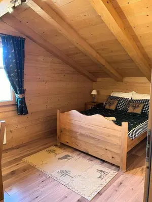 a bedroom with a bed in a log cabin at Chalet Medonnet - CHALET 10 personnes Combloux MAE-7241 in Combloux