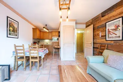 a living room with a table and a couch at Le Regency - à 5 min à pied des pistes in Saint-Gervais-les-Bains