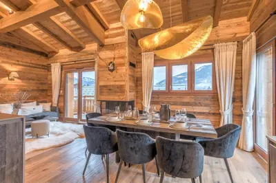 a dining room with a table and chairs at Appartement Mady - Welkeys in Megève