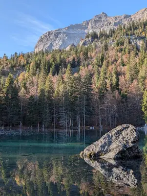 a rock in the middle of a lake at Appartement avec vue magnifique in Saint-Gervais-les-Bains