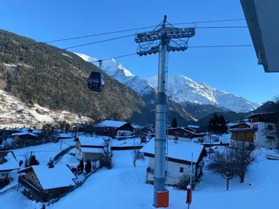 a ski resort with snow covered mountains and a ski lift at Appartement avec vue magnifique in Saint-Gervais-les-Bains