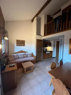 a living room with a bed and a table at Samoëns 2 in Samoëns