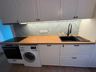 a kitchen with a sink and a washing machine at MontBlancViewApartment in Chamonix-Mont-Blanc