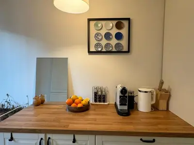 a kitchen with a counter with a bowl of fruit on it at MontBlancViewApartment in Chamonix-Mont-Blanc