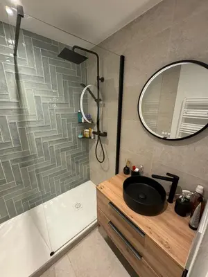 a bathroom with a sink and a shower with a mirror at MontBlancViewApartment in Chamonix-Mont-Blanc
