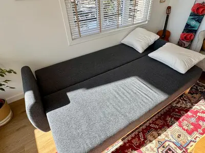 a large black bed in a room with a guitar at MontBlancViewApartment in Chamonix-Mont-Blanc