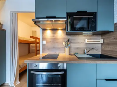 a kitchen with a sink and a microwave at Le Doina 2 N08 - ST5M in Morillon