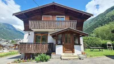 a small wooden house with a balcony on top at Apartment Plan de l'Aiguille - Garden Chx Center in Chamonix-Mont-Blanc