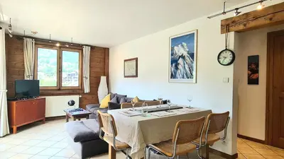 a living room with a table and a couch at Apartment Plan de l'Aiguille - Garden Chx Center in Chamonix-Mont-Blanc
