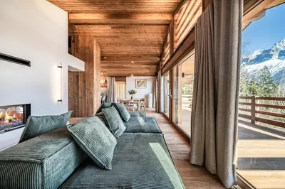 a living room with a couch and a large window at Chalet Foxden, Les Houches Chamonix - by EMERALD STAY in Les Houches