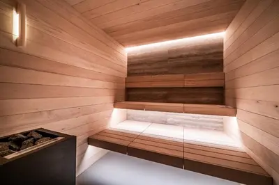 a sauna with a bench in a wooden wall at Chalet Foxden, Les Houches Chamonix - by EMERALD STAY in Les Houches