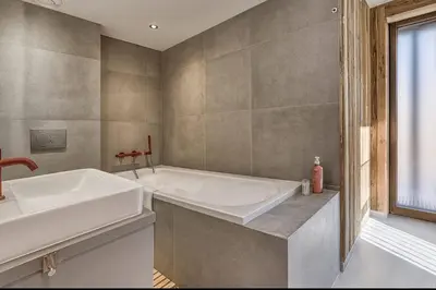 a bathroom with a tub and a sink at RUBY - Luxurious duplex 180 m2 in Chamonix-Mont-Blanc
