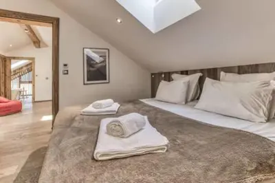 a bedroom with two beds with towels on them at RUBY - Luxurious duplex 180 m2 in Chamonix-Mont-Blanc