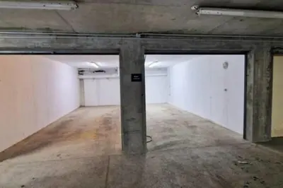 an empty room with two garage doors in a building at RUBY - Luxurious duplex 180 m2 in Chamonix-Mont-Blanc