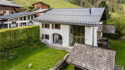 a white house with snow on the ground at Chalet Grelettes in Les Houches