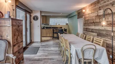 a kitchen and dining room with a table and chairs at Chalet Grelettes in Les Houches