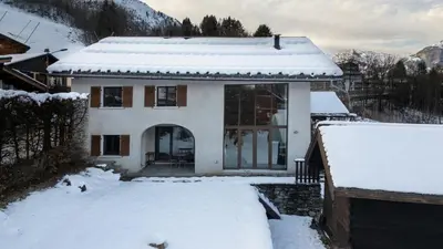 a house in the mountains with a yard at Chalet Grelettes in Les Houches