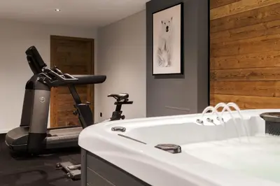 a bathroom with a treadmill next to a sink at La Combe Blanche - Balcon sur le Mont-Blanc in Combloux