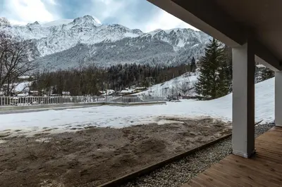 a view of a snow covered mountain from a porch at The Bear - Sauna Piscine - Face au Kandahar in Les Houches