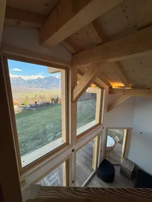 a room with two large windows in a tiny house at Le Mazot de L'Arpenaz in Combloux