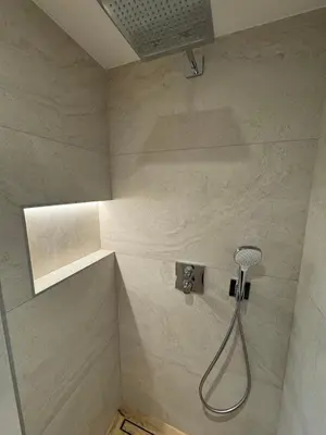 a shower in a bathroom with a shower head at Le Mazot de L'Arpenaz in Combloux