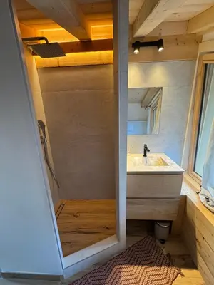 a bathroom with a sink and a mirror at Le Mazot de L'Arpenaz in Combloux