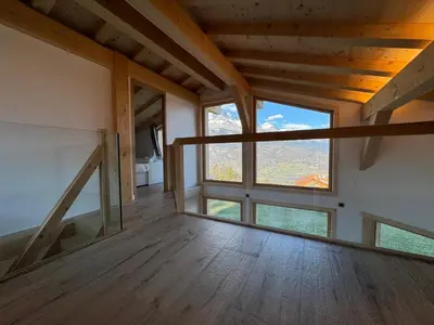 a room with a large window in a house at Le Mazot de L'Arpenaz in Combloux