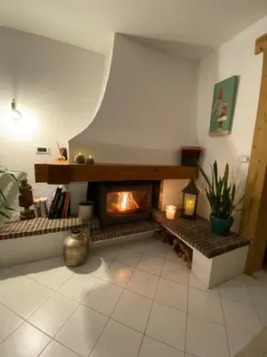 a living room with a fireplace in the middle at Apartment Chamonix Brise du Mont in Chamonix-Mont-Blanc