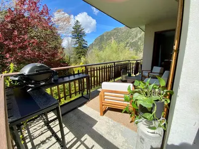a balcony with a grill and a bench at Apartment Chamonix Brise du Mont in Chamonix-Mont-Blanc
