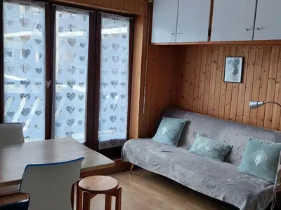 a living room with a couch and a table at Appartement cosy avec balcon et parking à Chamonix, proche centre-ville - FR-1-517-70 in Chamonix-Mont-Blanc