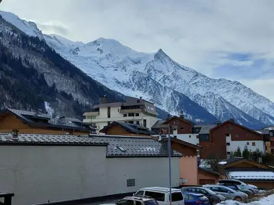 a town with cars parked in front of a mountain at Appartement cosy avec balcon et parking à Chamonix, proche centre-ville - FR-1-517-70 in Chamonix-Mont-Blanc