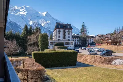 a view of a building with a mountain in the background at Appartement des Champs - Welkeys in Chamonix-Mont-Blanc
