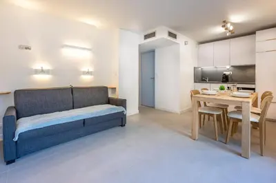 a living room with a couch and a table at Appartement des Champs - Welkeys in Chamonix-Mont-Blanc