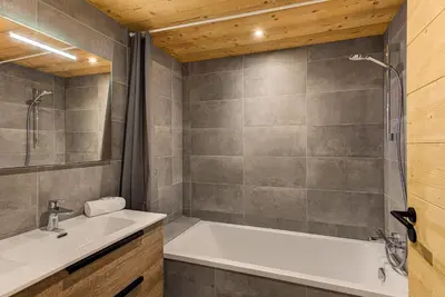 a bathroom with a tub and a sink at Apartment Annapurna, Alpes Travel, Les Houches, Sleeps 5 in Les Houches