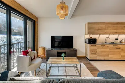 a living room with a couch and a table at Apartment Annapurna, Alpes Travel, Les Houches, Sleeps 5 in Les Houches