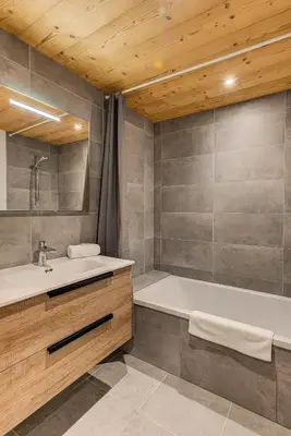 a bathroom with a tub and a sink at Apartment Annapurna, Alpes Travel, Les Houches, Sleeps 5 in Les Houches