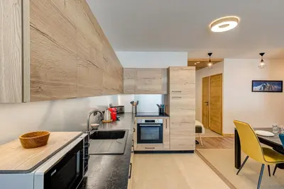 a kitchen with a counter and a dining room at Apartment Annapurna, Alpes Travel, Les Houches, Sleeps 5 in Les Houches