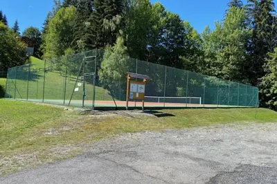 a chain link fence with a tennis court on it at Cozy Apartment with Balcony Saint-Gervais in Saint-Gervais-les-Bains