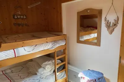 a room with two bunk beds and a mirror at Cozy Apartment with Balcony Saint-Gervais in Saint-Gervais-les-Bains