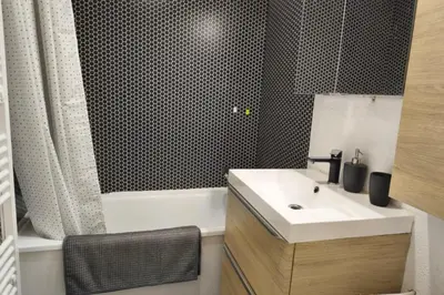 a bathroom with a sink and a bath tub at Cozy Apartment with Balcony Saint-Gervais in Saint-Gervais-les-Bains