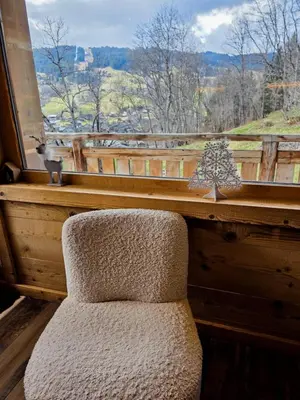 a wooden table with blue plates on top of it at Chalet Jeane proche du Centre ville de Megève in Megève