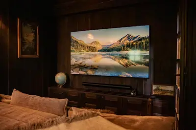 a living room with a flat screen tv on a wall at Chalet de Luxe 5 chambres Vue MontBlanc ,Spa, Jacuzzi, Salle de sport in Saint-Gervais-les-Bains